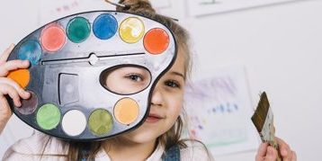 cute-girl-sitting-with-palette-paint-brush_23-2148037855