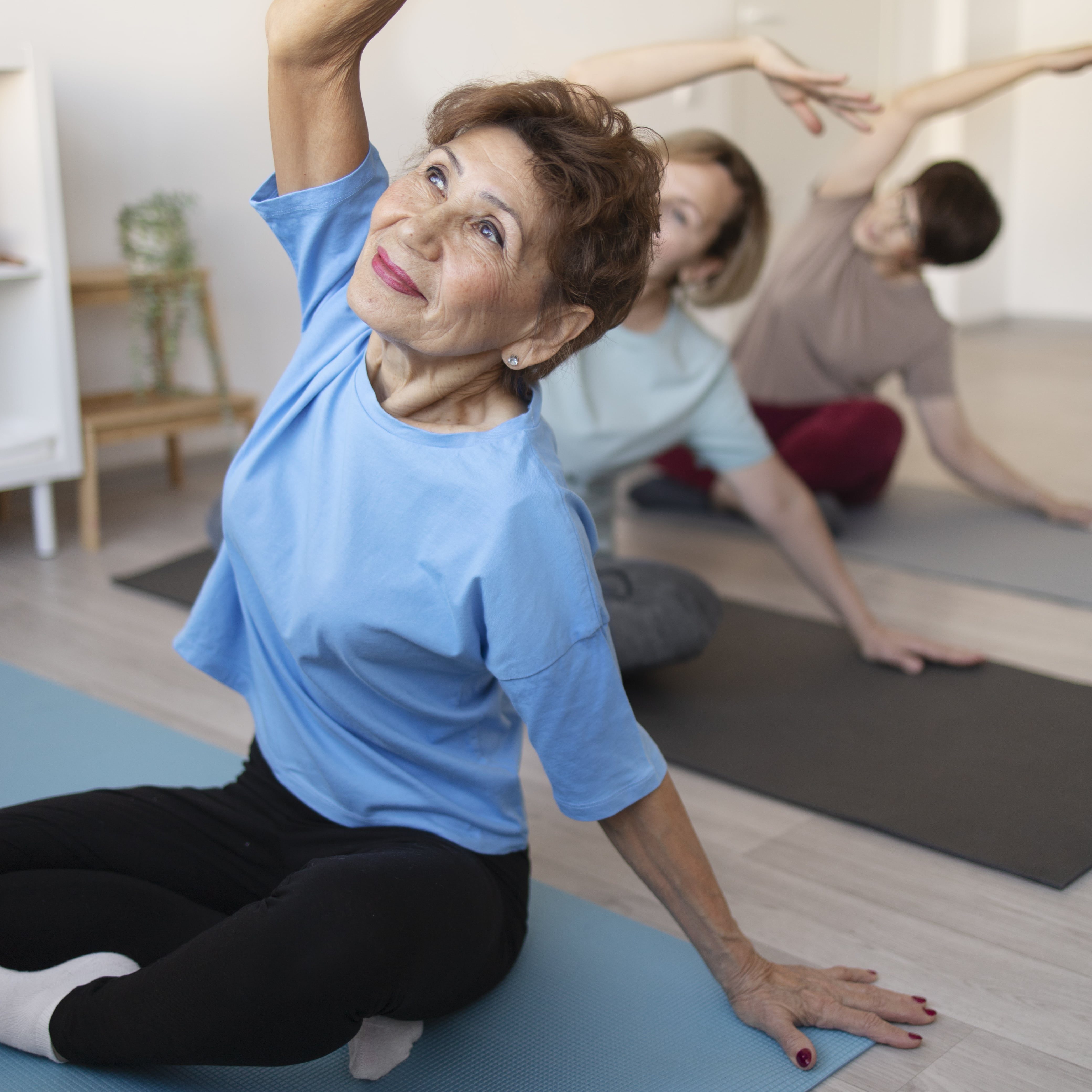 senior-women-doing-yoga-fitness-together-home-min